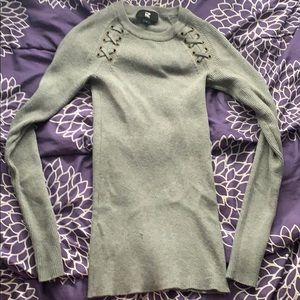 Long, gray, form-fitting sweater